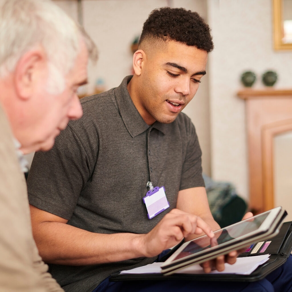Young man providing IT support on a tablet