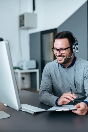 Man learning at computer after getting an IT support job in Ipswich